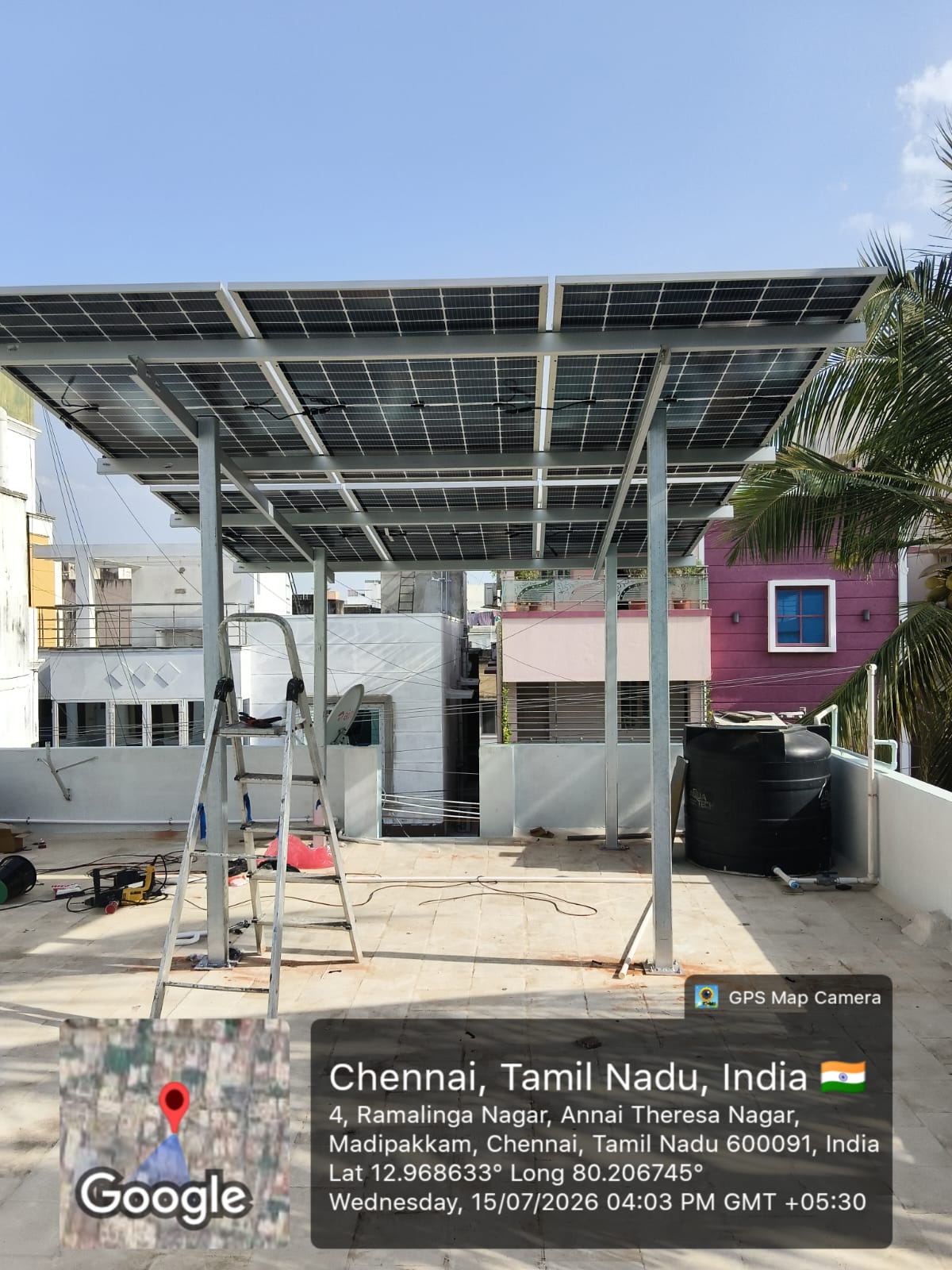 Solar panel installation at Madipakkam, Chennai — full-terrace solar canopy structure.
