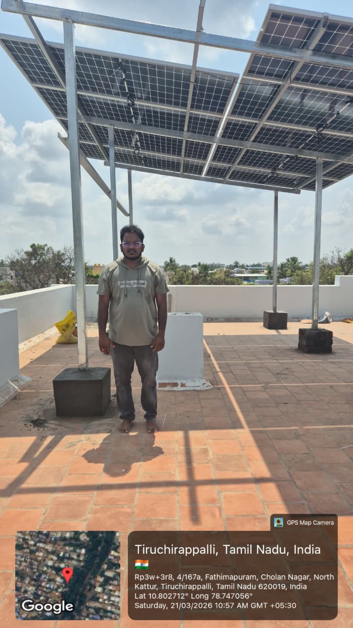 Solar panel installation at Cholan Nagar, Tiruchirappalli — elevated terrace canopy array.
