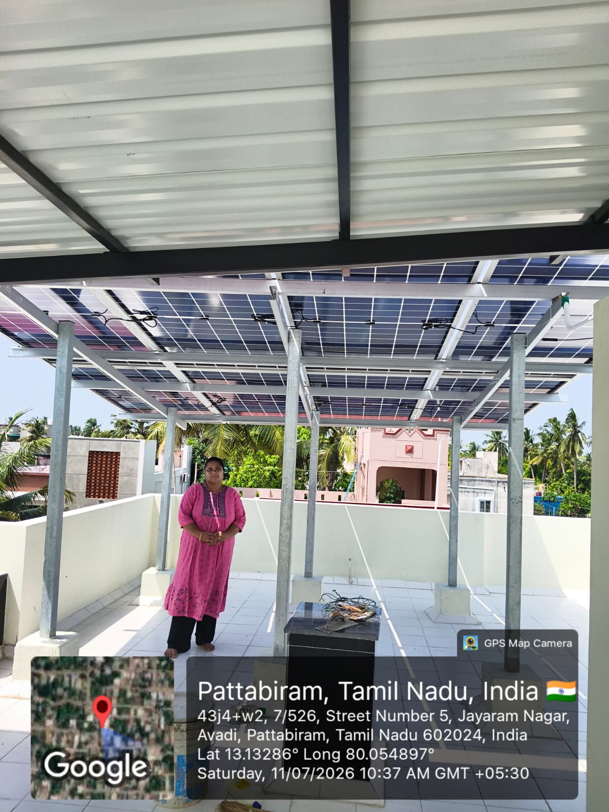 Solar panel installation at Pattabiram, Chennai — rooftop array under shaded terrace roofing.
